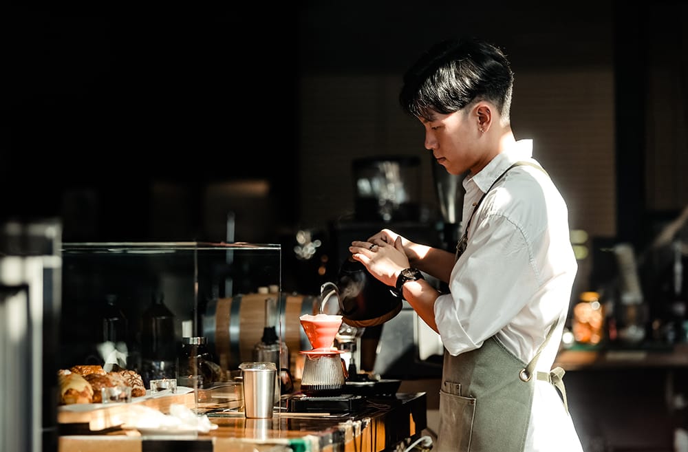 Student working behind a café bar